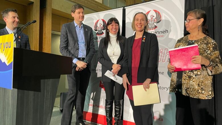 A group of people stand on a podium.