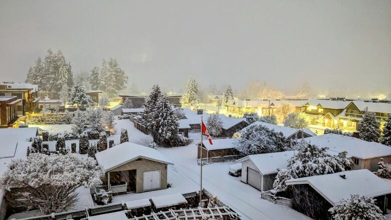 An overhead view of a snowy neighbourhood.