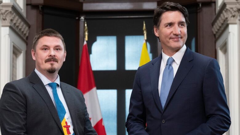 Two men pose for a photo