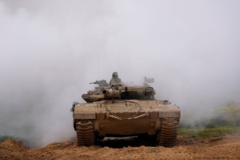 An Israeli army tank is seen on the move in southern Israel, near the Gaza border.