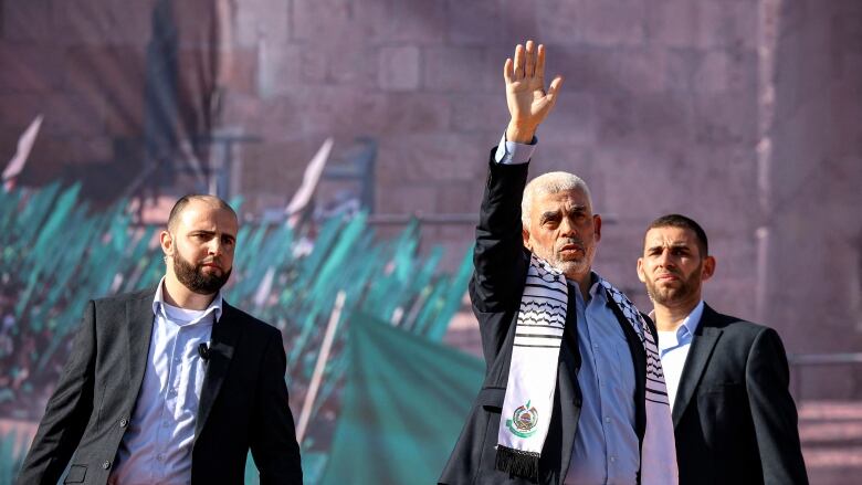 Yahia al-Sinwar (C), Gaza Strip chief of the Palestinian Islamist Hamas movement, waves to supporters during a rally marking the 35th anniversary of the group's foundation, in Gaza City on December 14, 2022. 