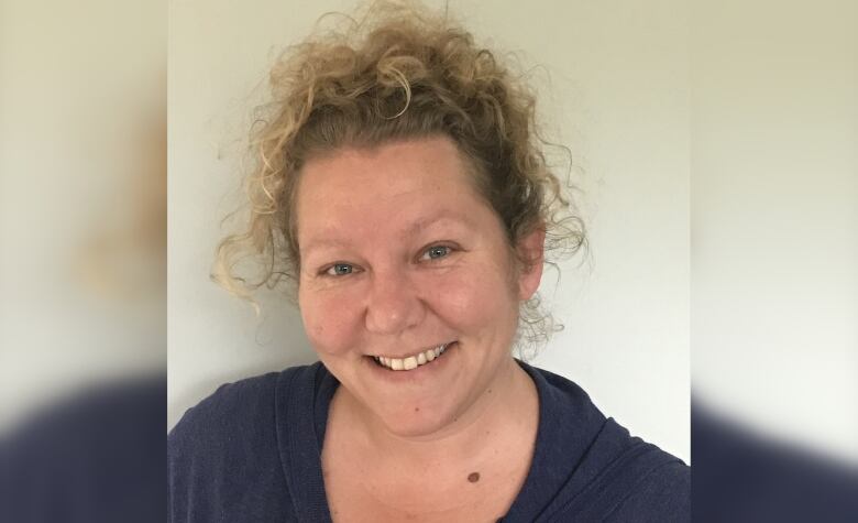 Head and shoulders shot of a smiling woman. 