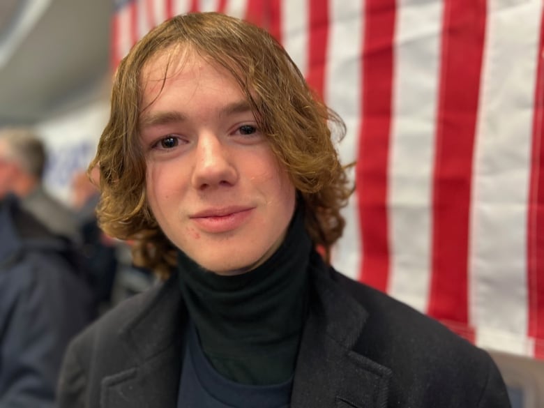 Profile shot of young man with long hair. 