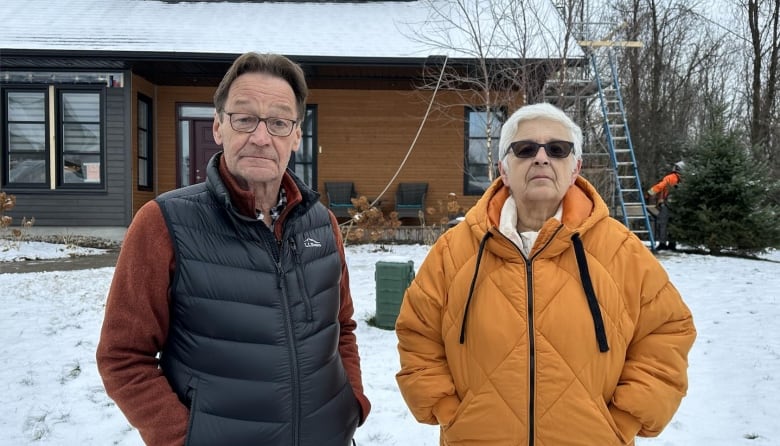 Myles Johnson and Andrea Hart standing in front of their house. 