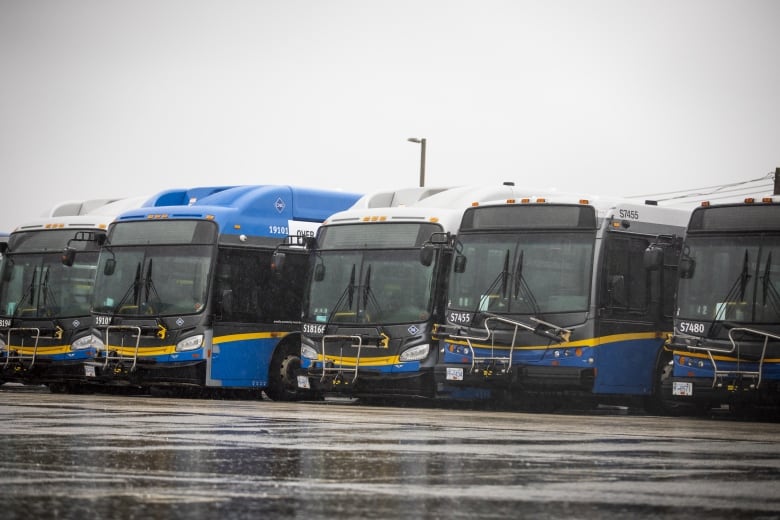 Empty buses are pictured at the Coast Mountain Bus Company Surrey bus depot in Surrey, British Columbia on Monday, January 22, 2024. 