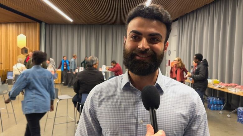 A man smiles at the camera.