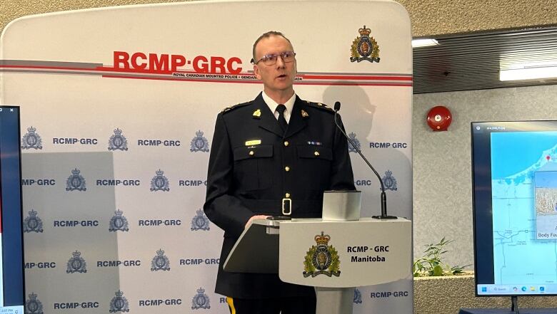 A man in a uniform stands behind a podium.