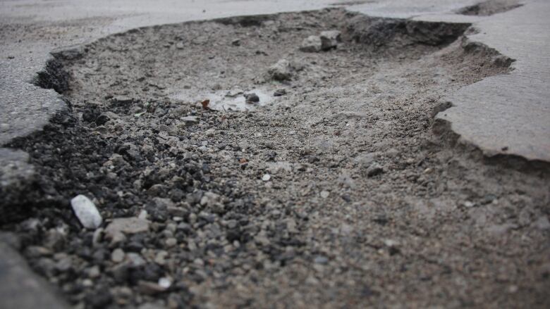 A pothole in a road