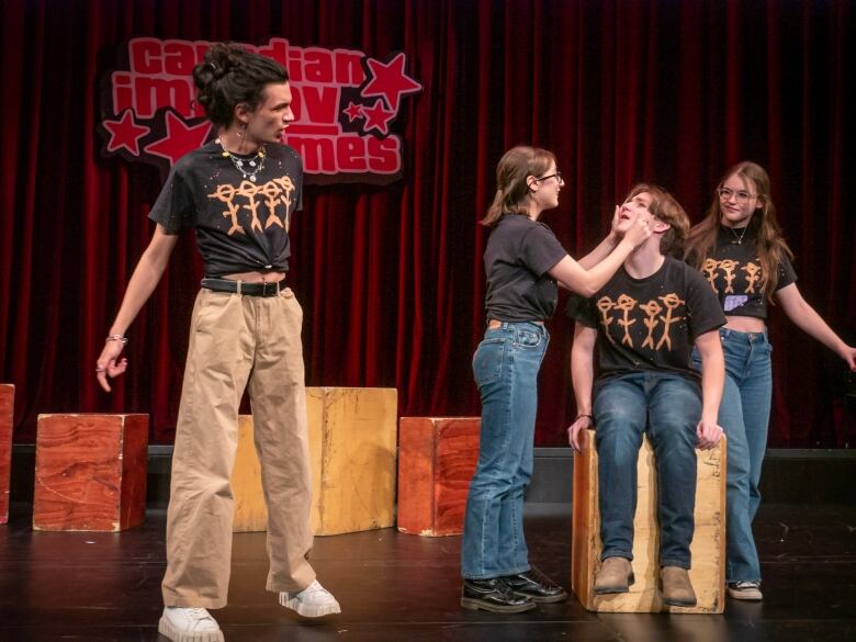 Four improv students perform using props.