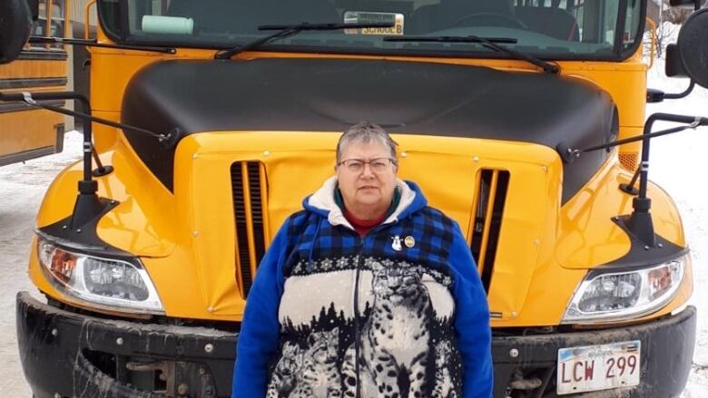 Woman standing in front of school bus