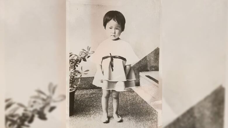 A sepia photo of a toddler.