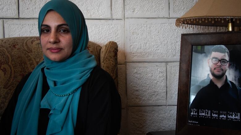 Mona Abdel Jabbar next to a photo of her 17 year old son Tawfic,  who was killed on January 19th by a group of Israels who fired shots at his pick up truck.