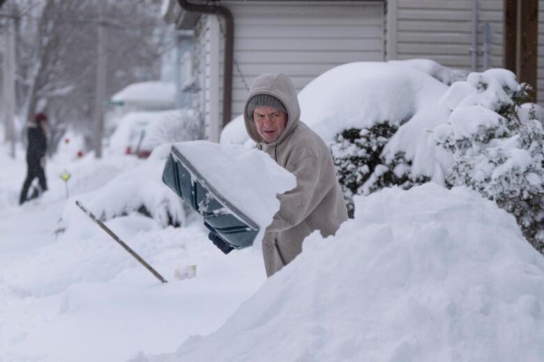 A person shovels snow.