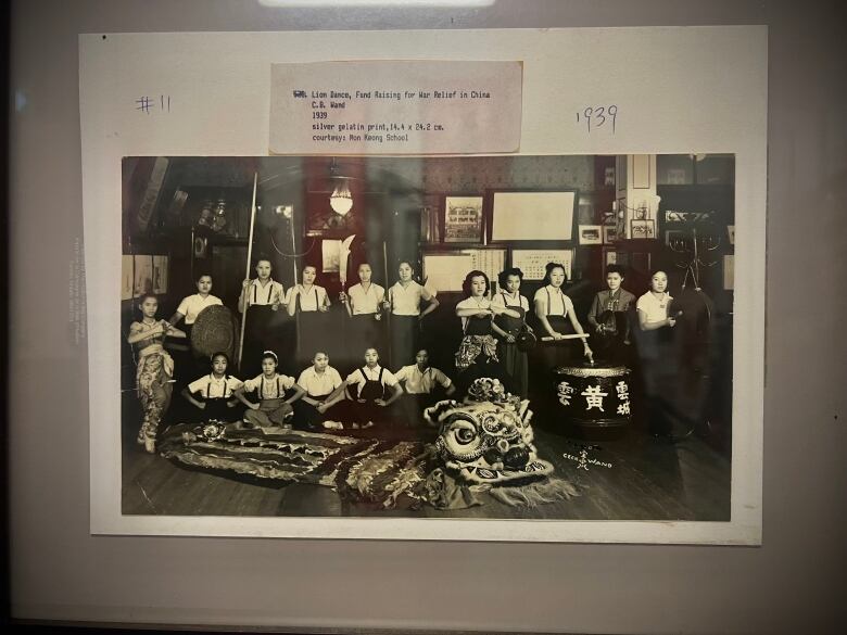 Black and white photo of women on a lion dance team. 