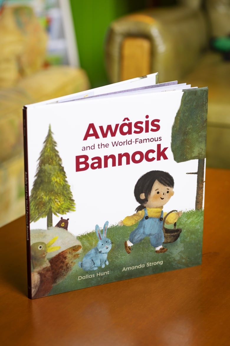 A picture book cover showing a young girl walks on the grass holding a basket. There is a bear, duck and rabbit in the background. 