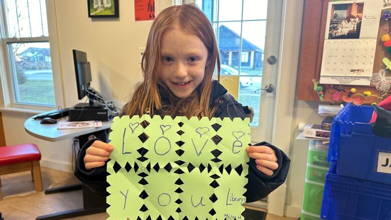 A young student made a poster showcasing her love for the Glanworth library, which along with the Carson branch, are both at risk of closing permanently. The libraries bring a sense of community and allow kids to develop through their various program.