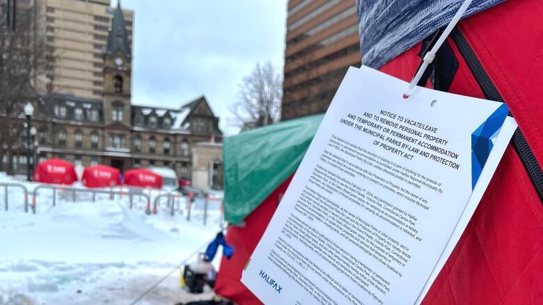 A piece of paper is shown attached to a red tent.