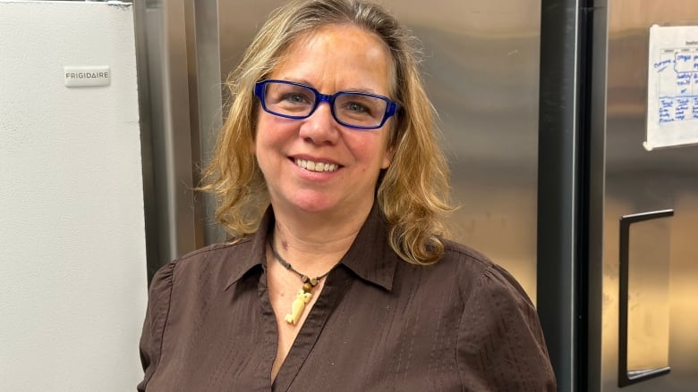 A woman with blonde hair and glasses.