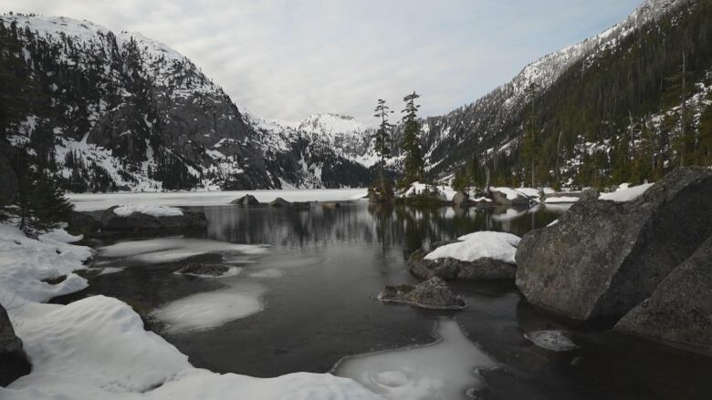 A lake is mostly melted with some ice remaining.