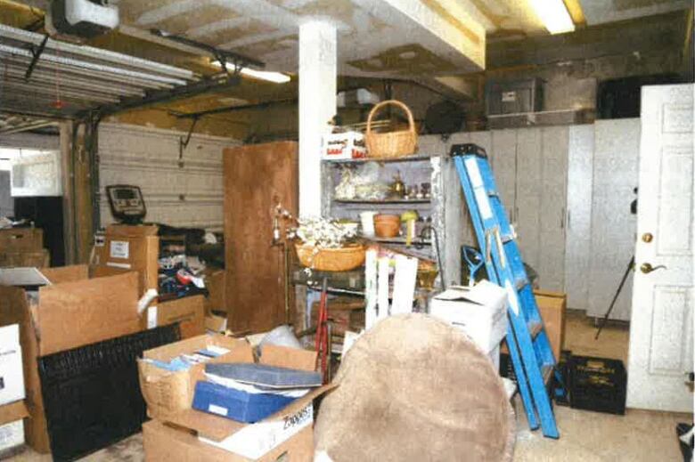 Boxes in a garage with a ladder nearby