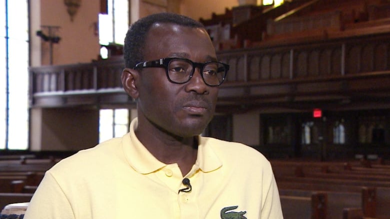 A man in a yellow shirt.