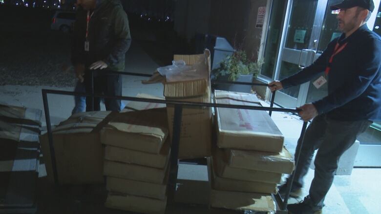 City and Red Cross staff load materials into the WFCU Centre to set up an emergency shelter for displaced residents of a downtown Windsor apartment building.