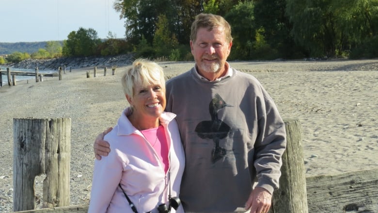 A portrait of two people on a beach.