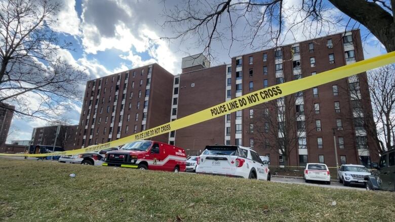 Police tape in front of an apartment building