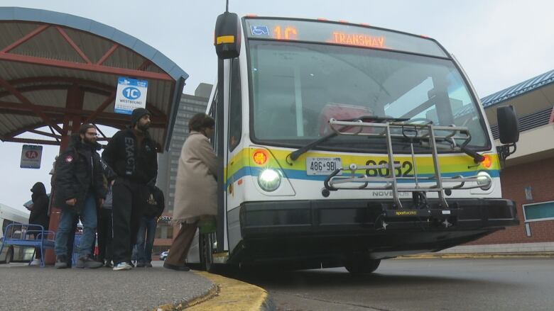 People boarding a public bus.