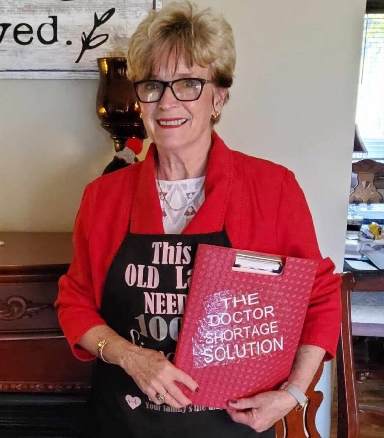 Marilyn Gifford of Sarnia, Ont. is pictured with a petition.