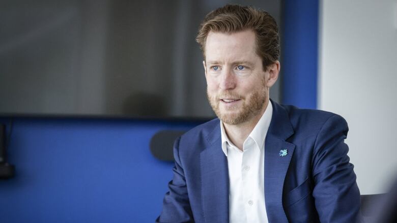 Portrait shot of WestJet CEO Alexis von Hoensbroech at a meeting hall. 