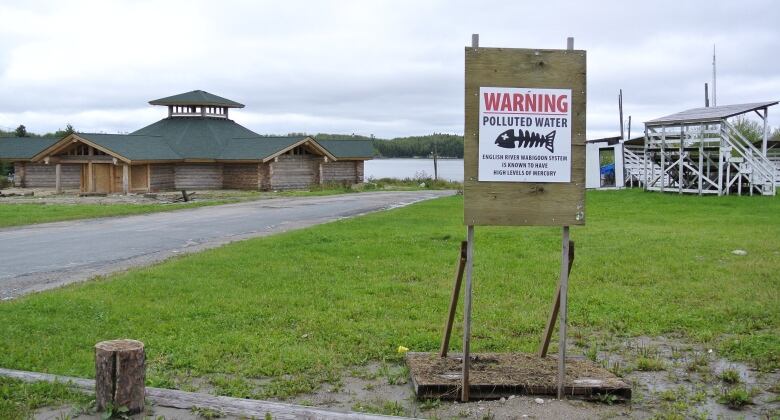 A sign by the water reads, 