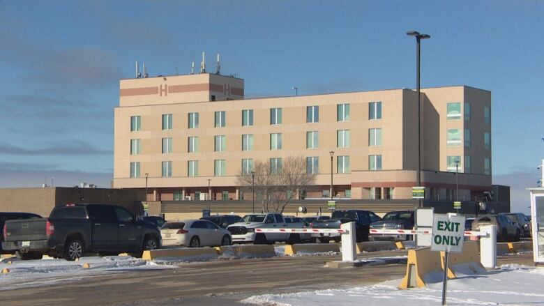 an exterior picture of the Victoria Hospital with snow on the ground and vehicles parked outside