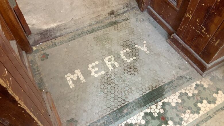 Floor tiles spelling the word 