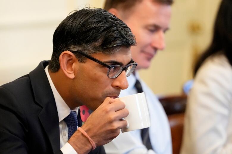 Britain's Prime Minister Rishi Sunak takes a sip from a mug as he chairs a cabinet meeting in 10 Downing Street on October 31, 2023 in London, England. 