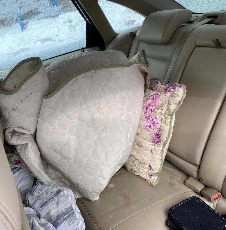 Pillows and blankets were left behind by the person who stole Dave Wilson's car.