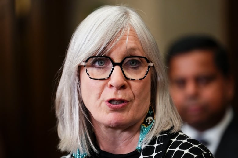 Indigenous Services Minister Patty Hajdu is pictured in the foyer of the House of Commons speaking to reporters.