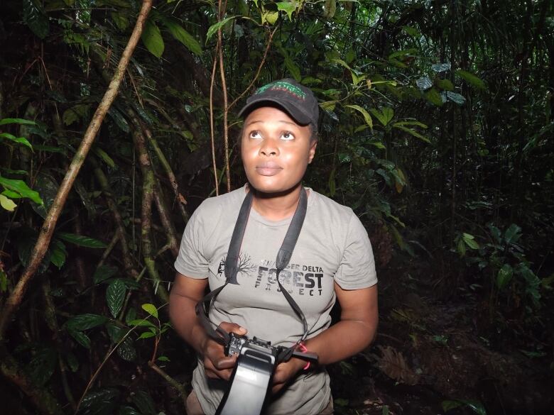 Rachel Ashegbofe Ikemeh, founder of the South-West/Niger Delta Forest Project, stands in the forest. 