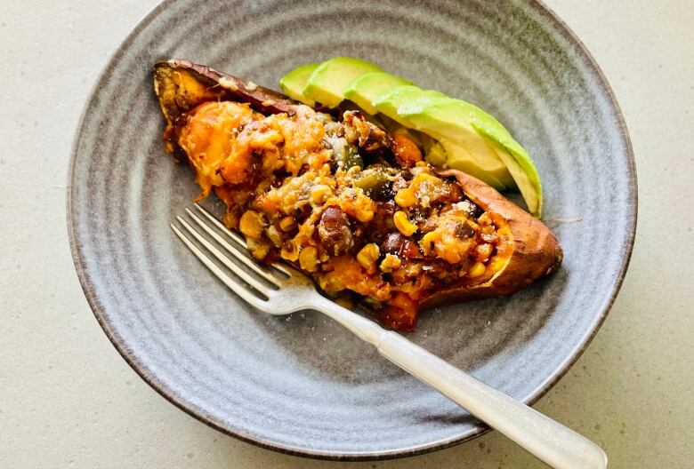 A close-up shot of stuffed sweet potatoes in a bowl.