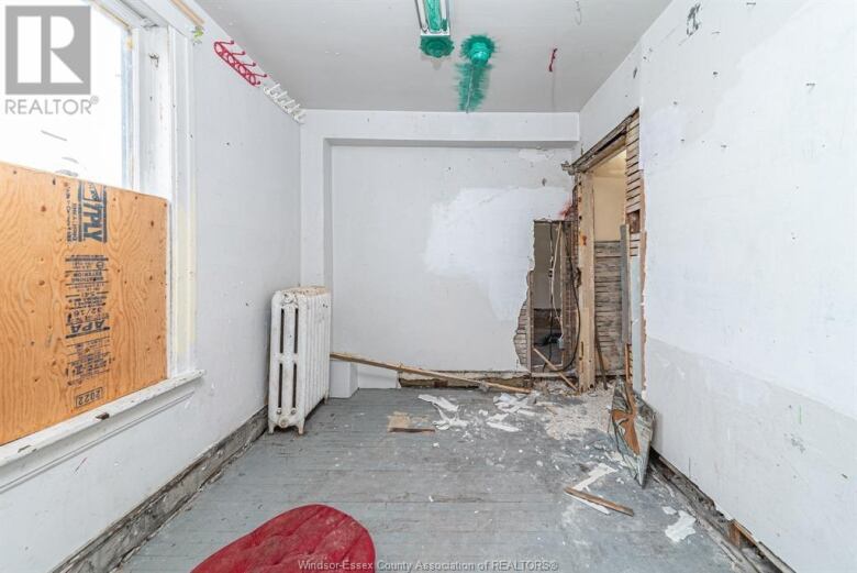 A room in a house in dire need of repair and renovation.