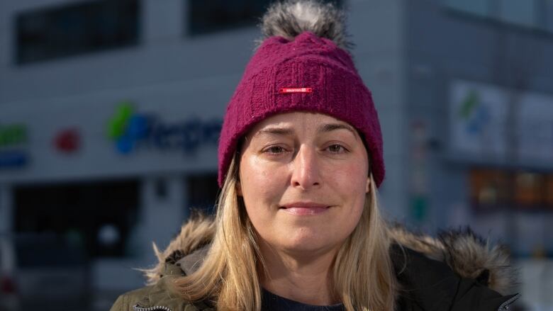 A city councillor poses for a photo outside in late winter.