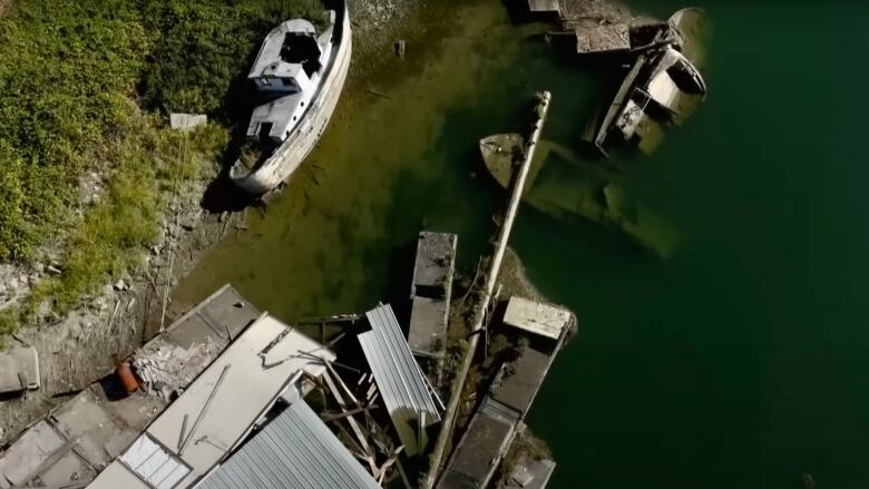 An aerial photo taken in October, 2023, shows multiple sunken and derelict boats on the Alouette River, along with a damaged boathouse, docks, and other junk.