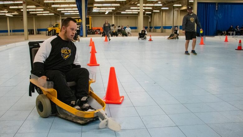 A player drives a motorized wheelchair for sports.