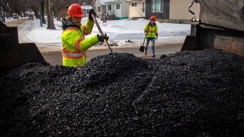 Workers dig for pothole filler.