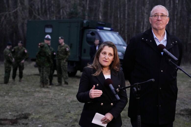 Deputy Prime Minister Chrystia Freeland, left, and Defence Minister Bill Blair talk to the media during a joint exercise in which Polish and Canadian troops provide training to soldiers from Ukraine