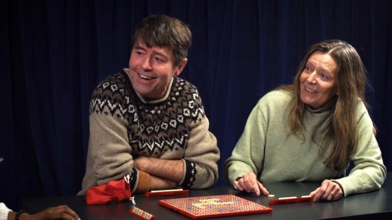 Two people playing scrabble. 