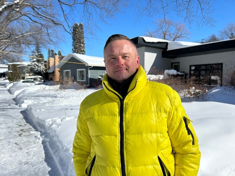 A man in a yellow jacket.