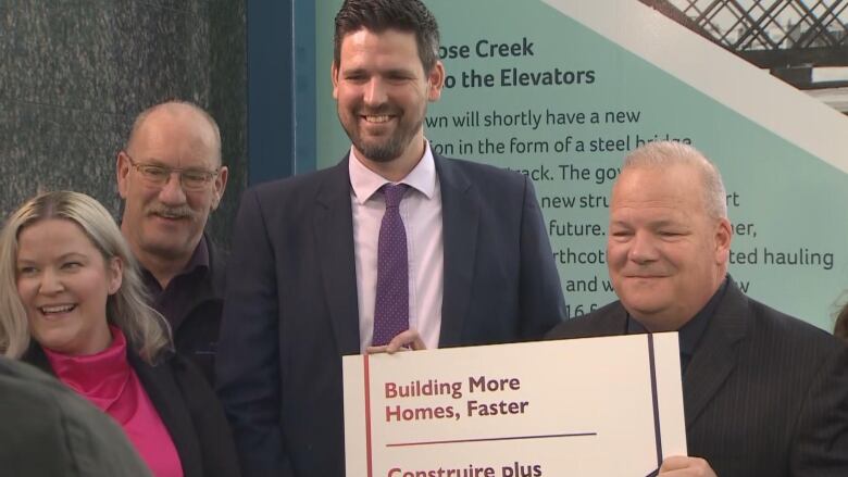 Federal housing minister Sean Fraser (centre) announced the investment at an event on Tuesday alongside Airdrie mayor Peter Brown.  