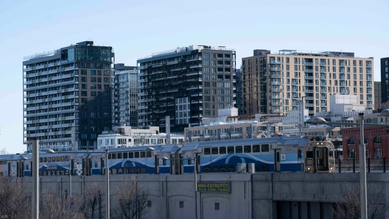 a commuter train seen on city backdrop