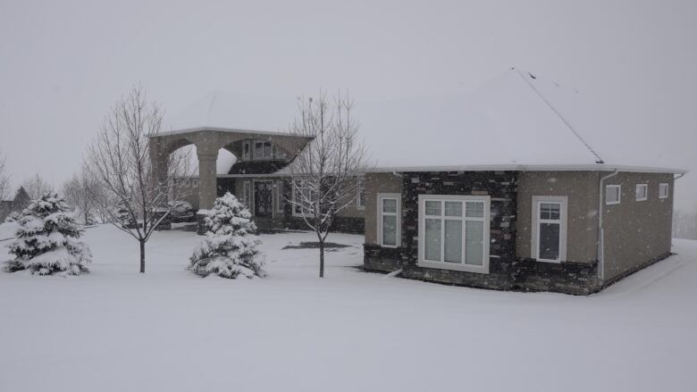 A house on a snow-covered rural property.